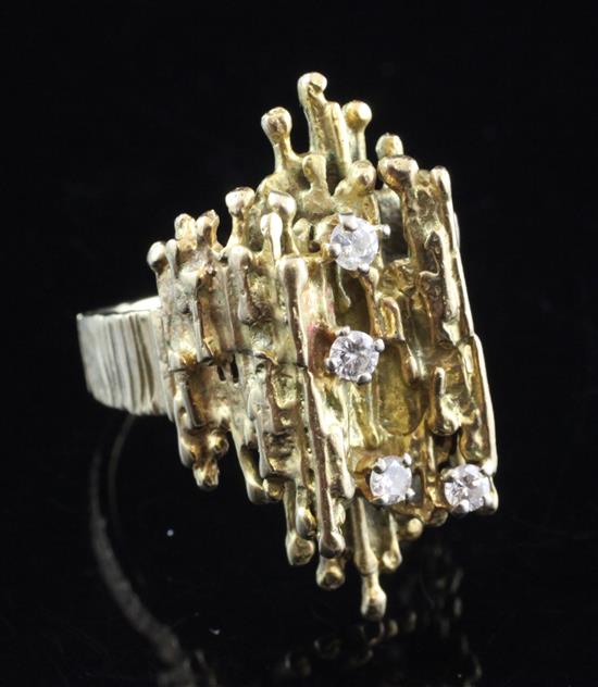 Modernist gold cocktail ring of abstract form set with four small diamonds, size O.